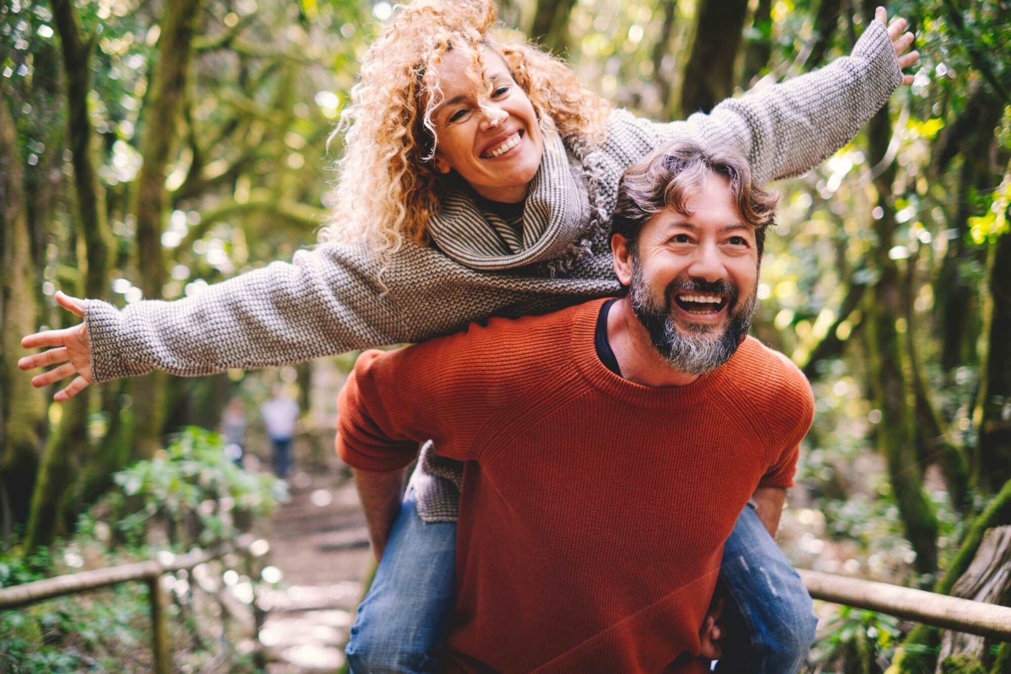 Overjoyed adult couple have fun together at outdoor