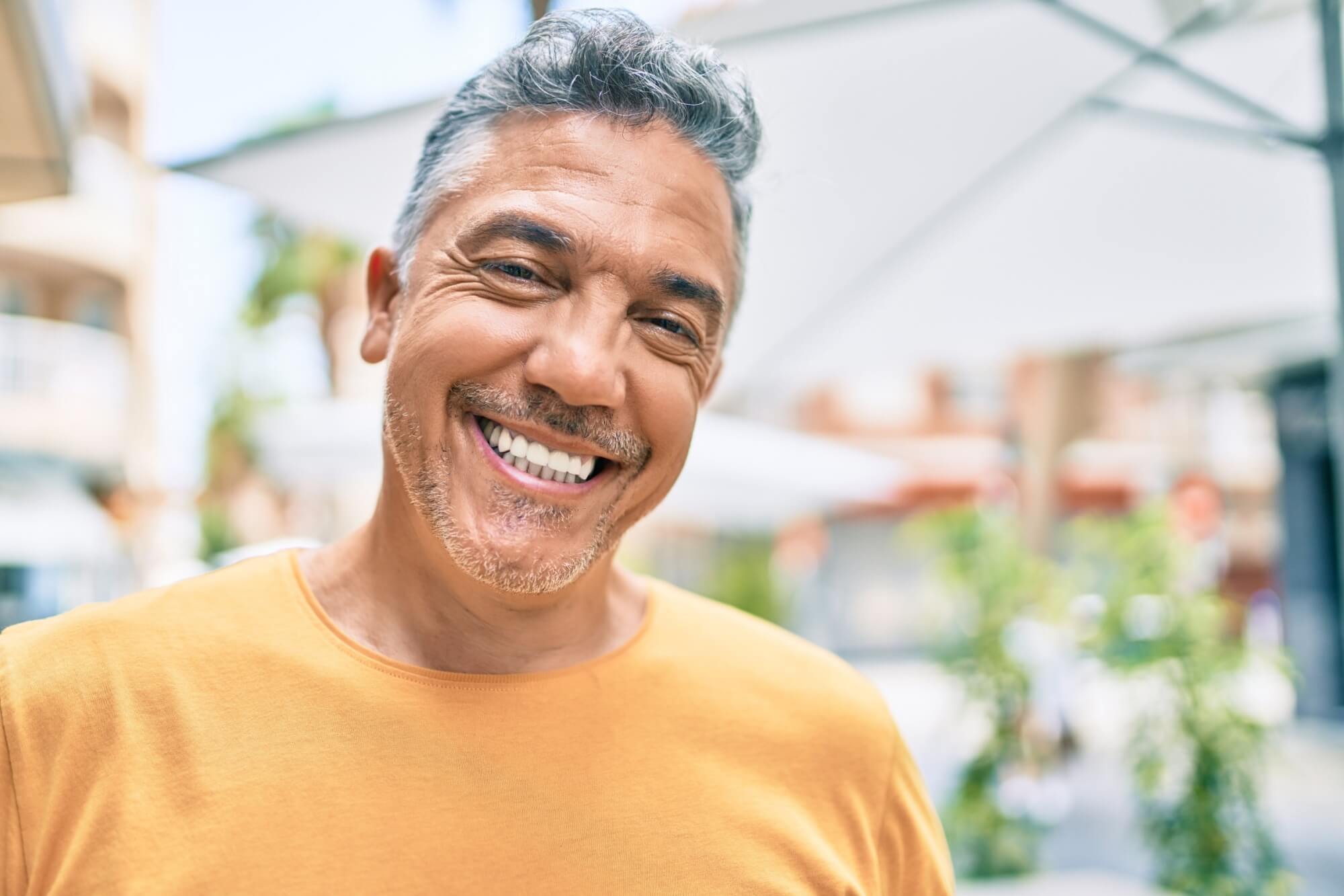 Middle age grey-haired man smiling
