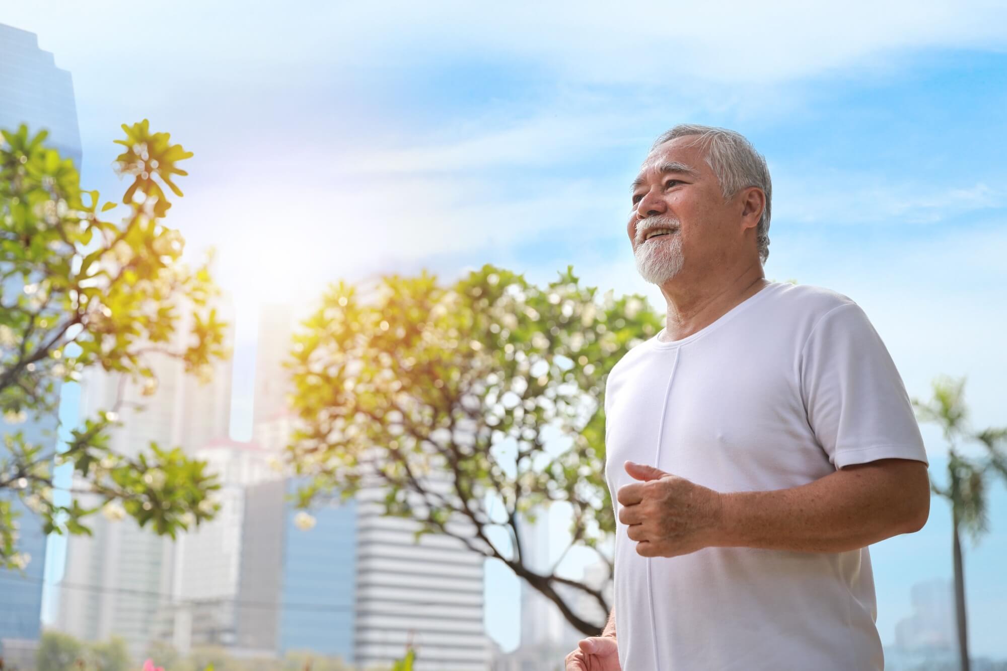 smiling senior man doing exercise and jogging