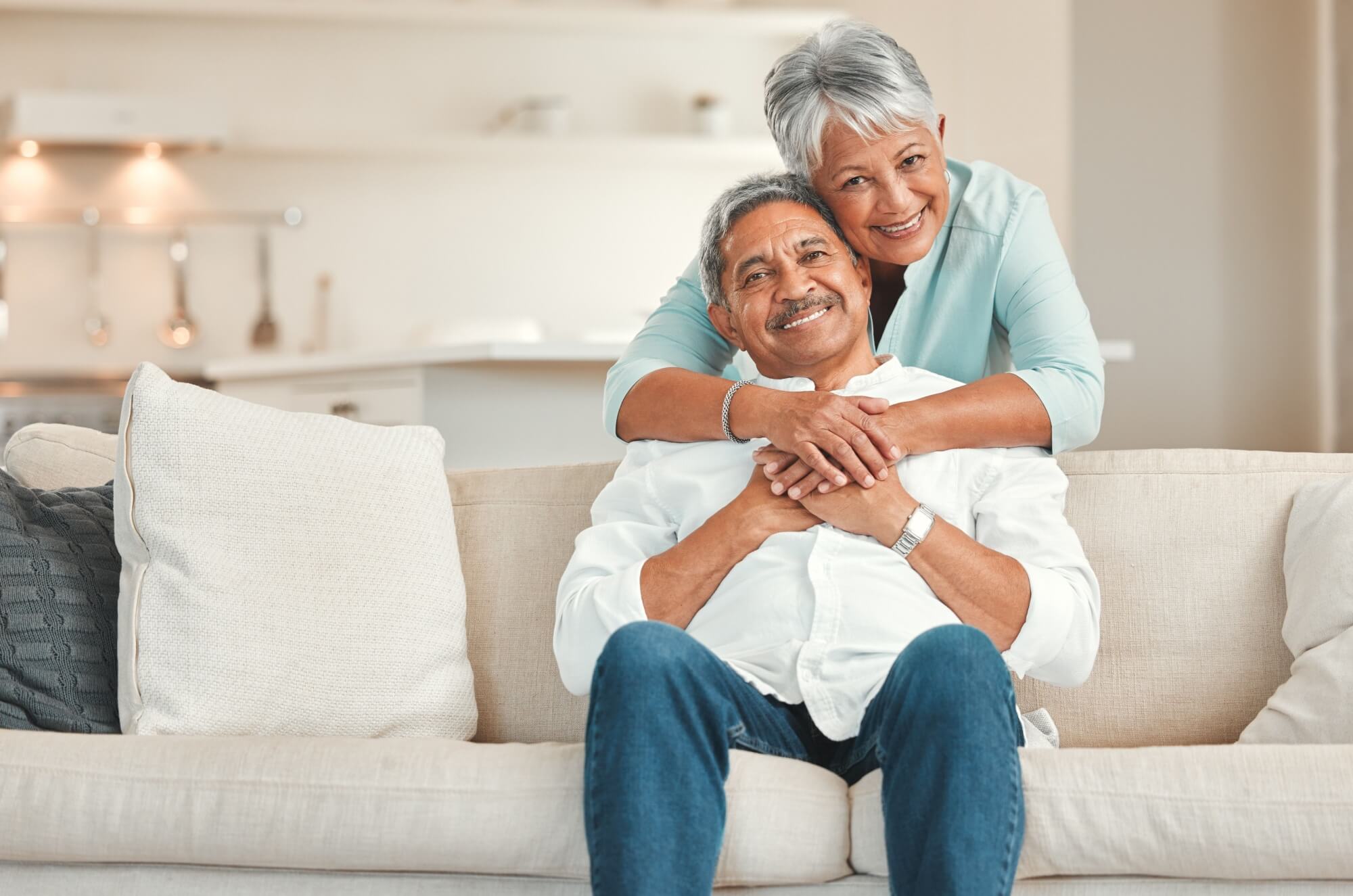 happy senior couple relaxing on the sofa at home