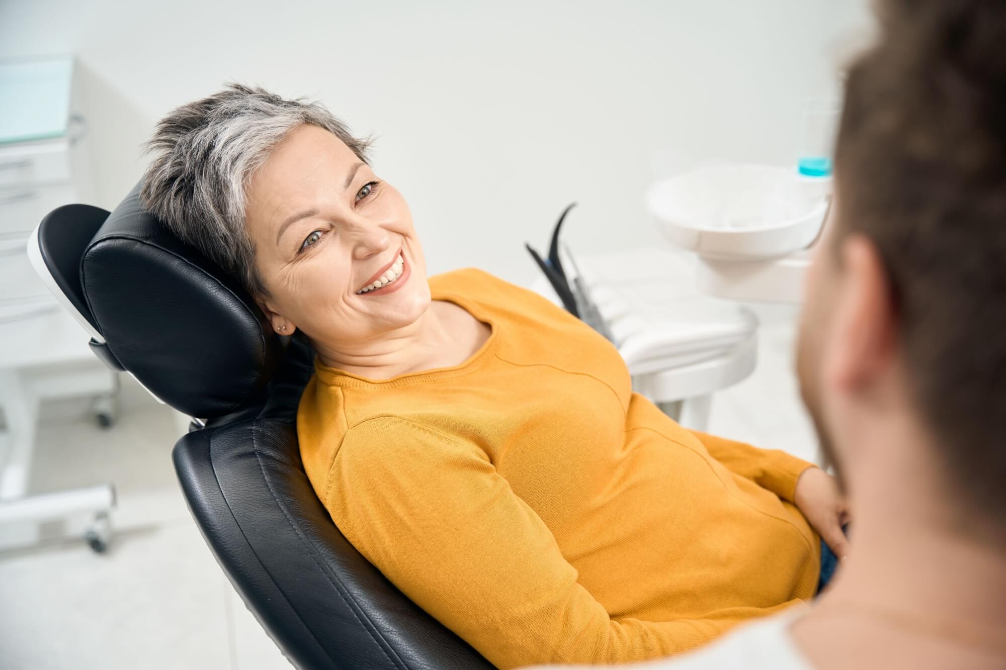 Woman client looking at doctor and smiling