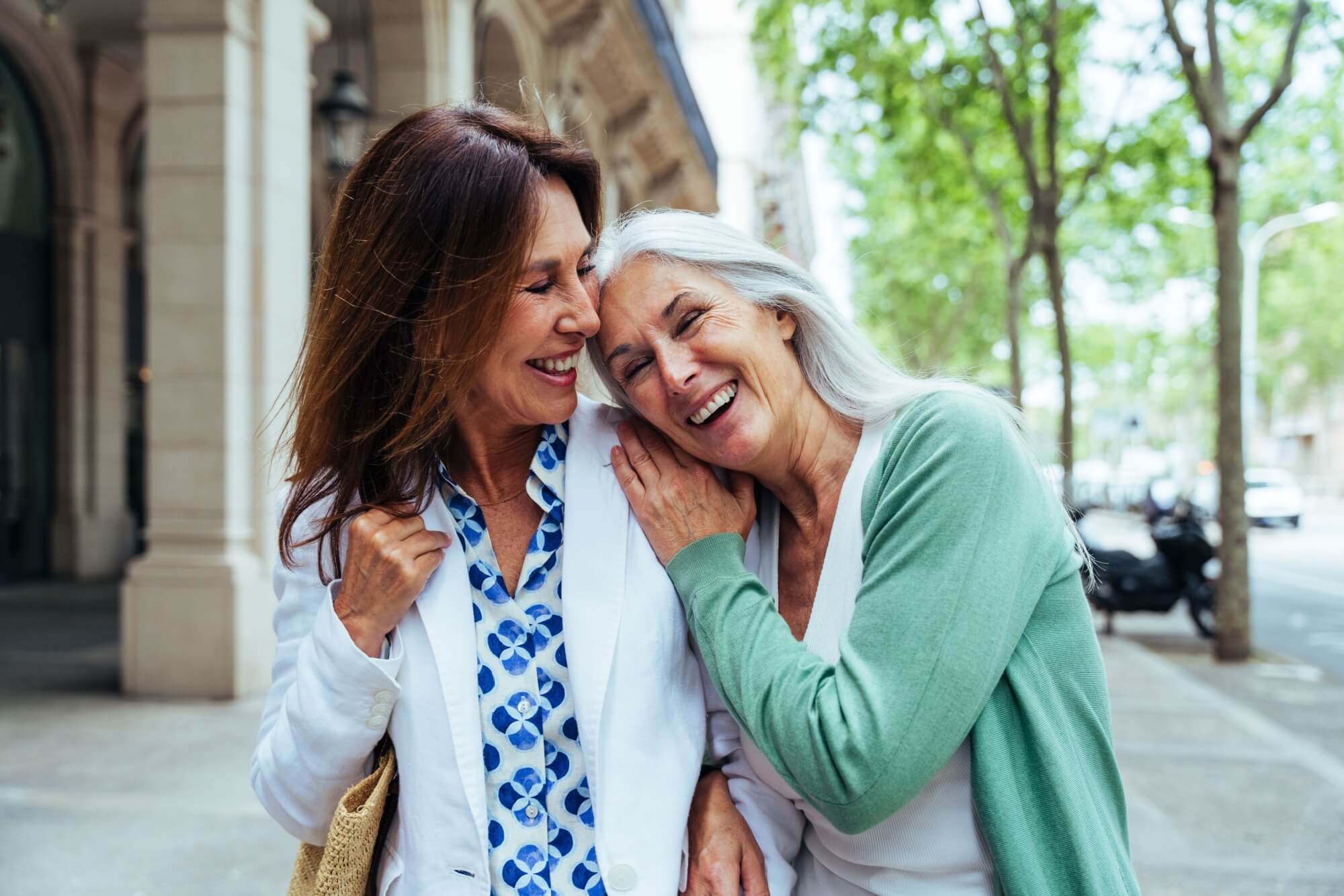 Beautiful senior women bonding outdoors in the city
