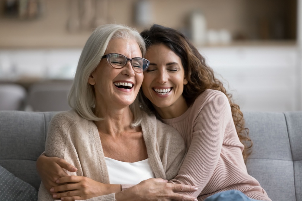 Happy excited senior mom and adult daughter woman having fun at home