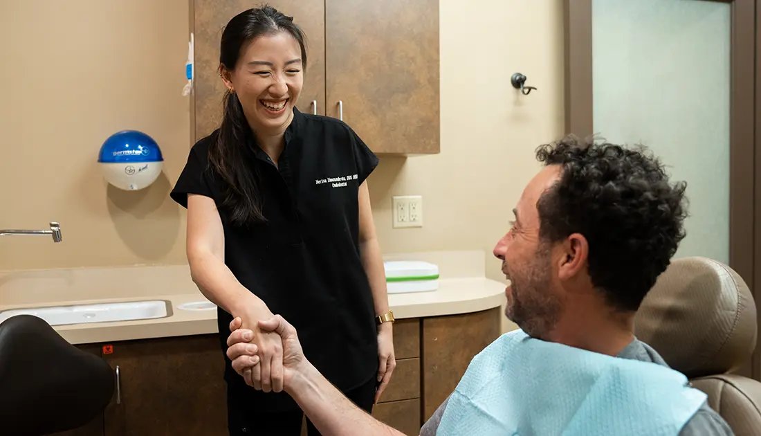 Patient shaking hand with Female Dentist
