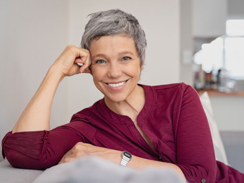 smiling senior woman relaxing on couch