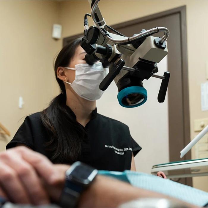 Female Dentist in treatment room treating patient