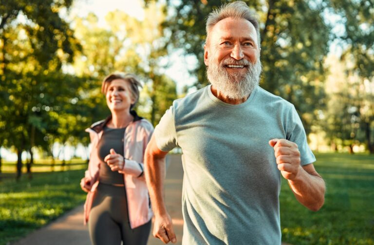 energetic fit sportsman spending morning in park and jogging