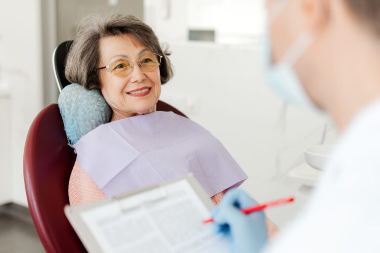Smiling, beautiful senior woman sitting in dental chair