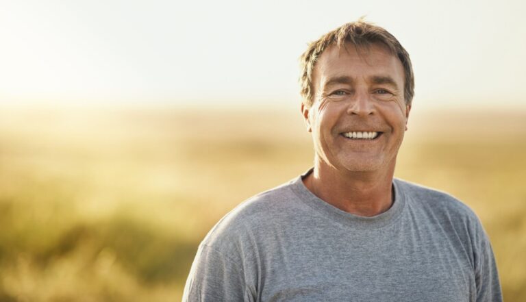 Senior man at field in summer for outdoor adventure