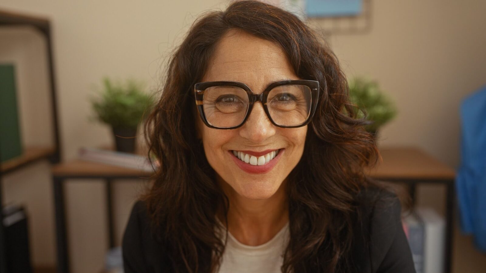 Smiling middle-aged woman with glasses at home