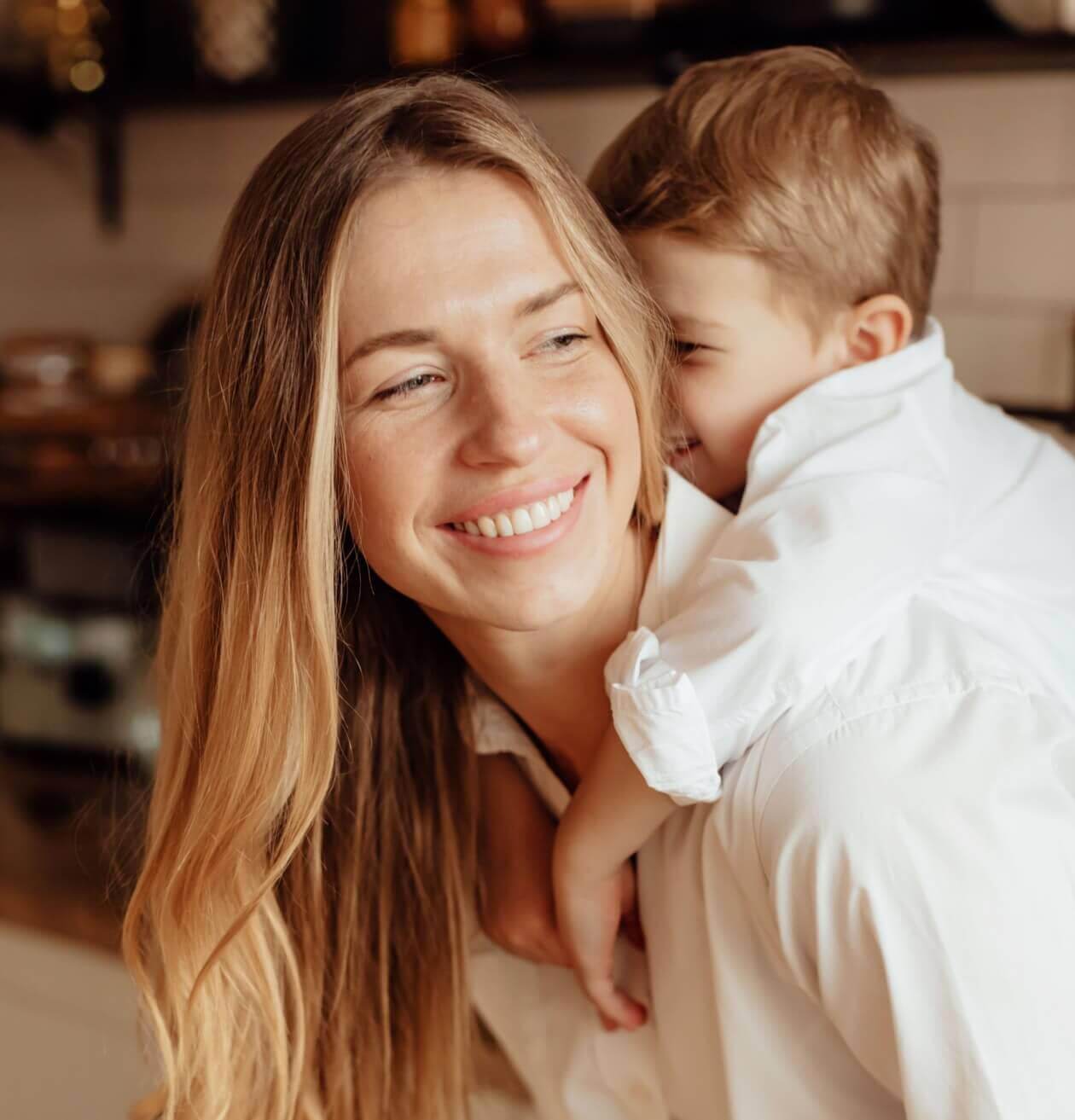 Happy mother and son smiling at each other affectionately